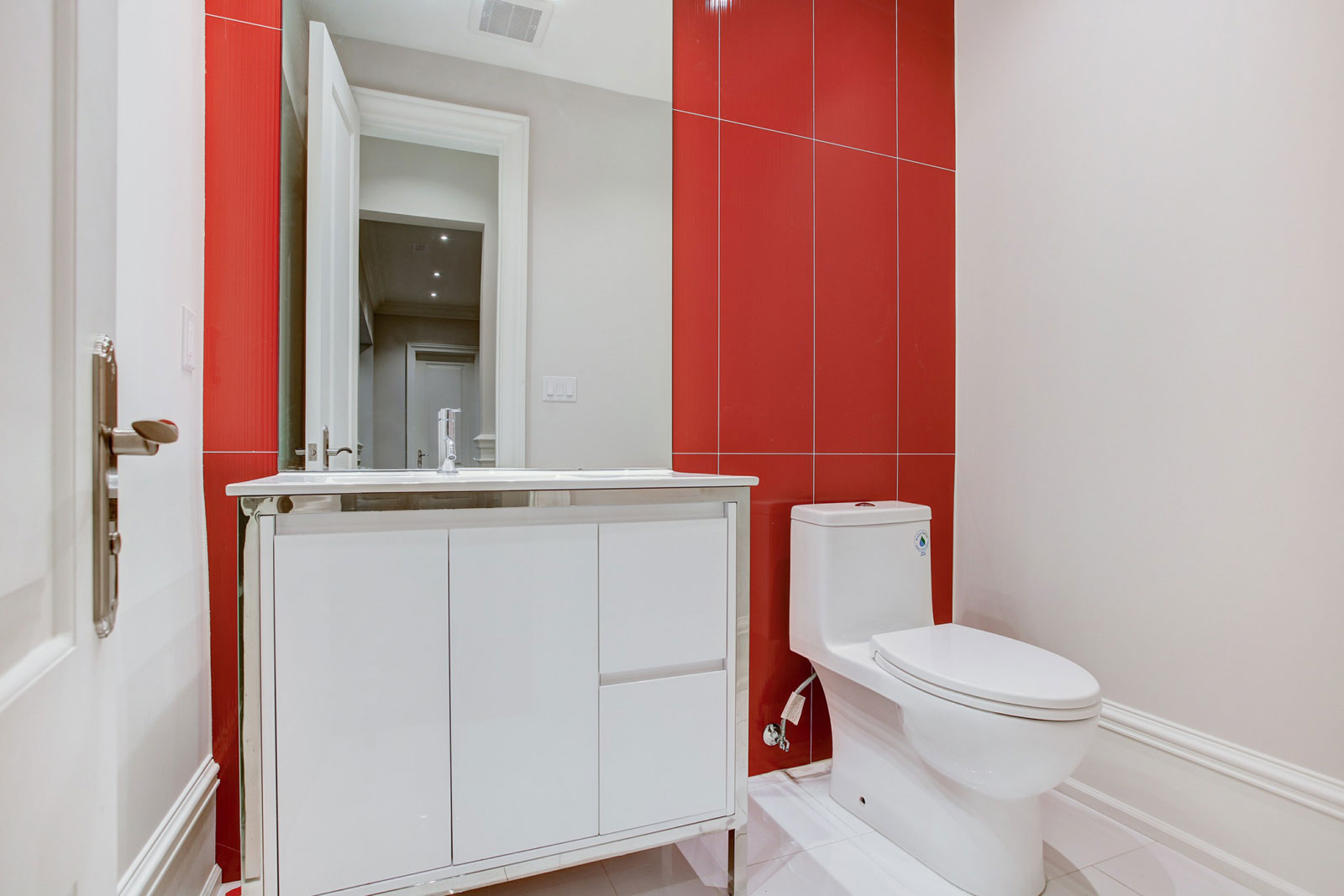 renovated condo bathroom with red and white interior walls