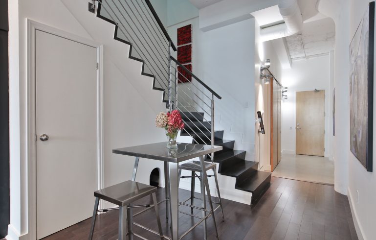 steel railing and wooden stairs in second floor staircase - condo upgrade ideas