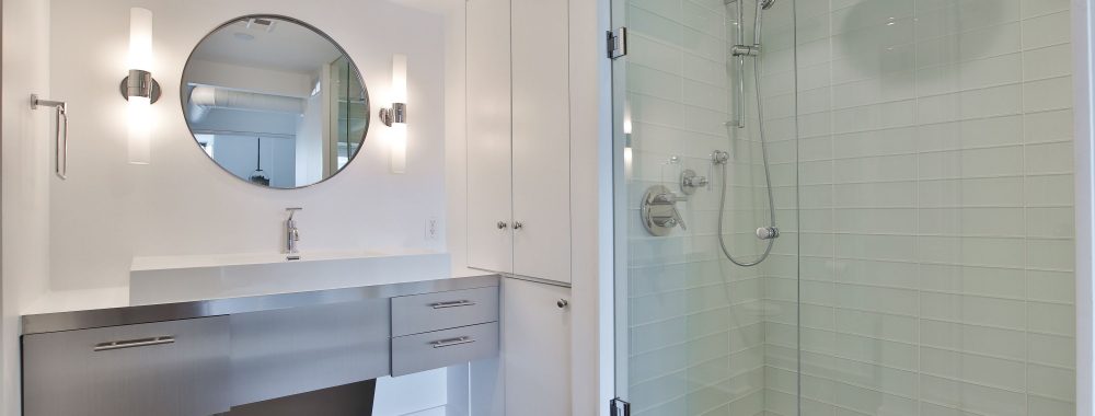 small bathroom with walk in shower and wall mirror - bathroom renovation condo